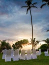 Beautiful romantic wedding ceremony under palm trees on the ocean beach at sunset