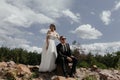 Romantic wedding couple posing on top of mountains at sunset with amazing view. Beautiful newlyweds on their wedding day Royalty Free Stock Photo