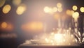 Romantic wedding reception table setting with candles and table cloth. Abstract unfocused bokeh. Glowing candles holiday dinner.