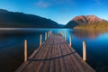 Romantic wharf on Lake Rotoiti, view ovelooking misty Saint Arnaud Ridge, all part of Nelson Lakes National Park in north od South