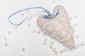 Romantic white-blue heart with a stone and a bow close-up on a white background for a card Royalty Free Stock Photo