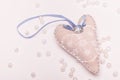 Romantic white-blue heart with a stone and a bow on a pink background for a card Royalty Free Stock Photo