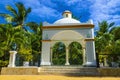 Romantic white wedding gazebo near the beach among palm tress