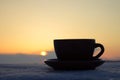 Romantic cup of coffee or tea in rays of sunset