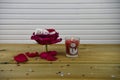 Romantic winter season photography image with red rose flower in a small jar and marshmallow snowman inside and lit candle Royalty Free Stock Photo