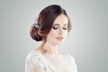 Romantic woman with bridal updo hair. Female face closeup