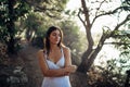 Romantic woman enjoying walk in the nature on a sunny morning.Mindful carefree female in natural environment feeling stress free