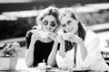 Romantic woman friends with coffee cup in cafe. Spending good time with best friend. Two beautiful women in sunglasses Royalty Free Stock Photo