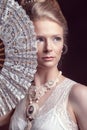 Romantic woman holding an oriental fan in front of her face Royalty Free Stock Photo