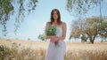 Romantic woman holding wildflowers at garden. Relaxed girl walking camomiles Royalty Free Stock Photo