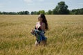 Romantic woman walking in golden fields of barley. sexy girl in field. summer holiday and vacation. Woman in wheat at the sun. Royalty Free Stock Photo