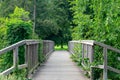 Romantic wooden bridge in the green forest