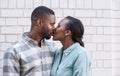 Romantic young African couple kissing each other in the city Royalty Free Stock Photo