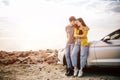 Romantic Young Attractive Couple Watching the Sunset and Kissing with Sports Car Royalty Free Stock Photo