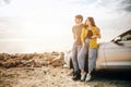 Romantic Young Attractive Couple Watching the Sunset and Kissing with Sports Car Royalty Free Stock Photo