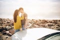 Romantic Young Attractive Couple Watching the Sunset and Kissing with Sports Car Royalty Free Stock Photo