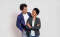 Romantic young business couple smiling and looking at each other while standing on white background Royalty Free Stock Photo