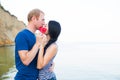 Romantic young caucasian couple kissing on the seaside hiding be Royalty Free Stock Photo