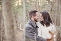 Romantic young couple alone in the forest on a cold winter day