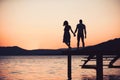 Romantic young couple on the beach in sunset or sunrise. Royalty Free Stock Photo