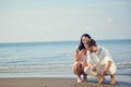 Romantic young couple draw heart shapes in the sand while on honeymoon. summer beach love concept. Royalty Free Stock Photo