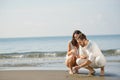 Romantic young couple draw heart shapes in the sand while on honeymoon. summer beach love concept. Royalty Free Stock Photo