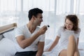 Romantic young couple enjoying cake together on the bed in bedroom Royalty Free Stock Photo