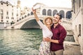 Romantic young couple enjoying vacation in Venice, Italy - Happy tourists visiting Italian city on summer holiday Royalty Free Stock Photo
