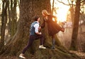 Romantic young couple happily having fun together in forest city park at sunset Royalty Free Stock Photo