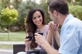 Romantic young couple having red wine in park Royalty Free Stock Photo
