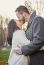 Romantic young couple kissing and laughing outside on a cold fall day Royalty Free Stock Photo