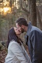 Romantic young couple kissing in the New England woods Royalty Free Stock Photo
