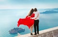 Romantic young couple in love over sea shore background. Fashion