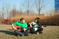 Romantic young couple portrait playing guitar under blue sky. Royalty Free Stock Photo
