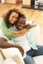 Romantic Young Couple Relaxing Sitting On Sofa Royalty Free Stock Photo