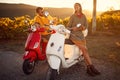 Romantic couple riding on a scooter in European