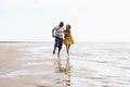 Romantic Young Couple Running Along Shoreline Royalty Free Stock Photo