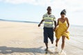 Romantic Young Couple Running Along Shoreline Royalty Free Stock Photo