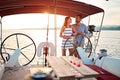 Romantic couple sailing on the luxury boat together and enjoy at sunset on vacation Royalty Free Stock Photo