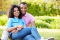 Romantic Young Couple Sitting In Garden