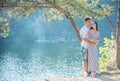 Romantic young couple standing on cliff over river Royalty Free Stock Photo