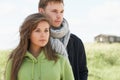 Romantic Young Couple Standing By Dunes With Beach Royalty Free Stock Photo