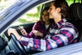 Romantic young couple in their car going on a road trip. Young man driving car with woman sitting by on a summer day. Woman Royalty Free Stock Photo