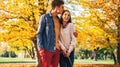 Romantic couple walking outdoors in autumn park with dogs Royalty Free Stock Photo