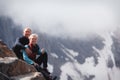 Romantic young happy couple kissing and hugging. rain and fog. Young couple in love on the background of mountains Royalty Free Stock Photo