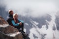 Romantic young happy couple kissing and hugging. rain and fog. Young couple in love on the background of mountains Royalty Free Stock Photo