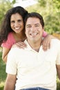 Romantic Young Hispanic Couple Relaxing In Park