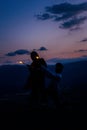Happy romantic couple dancing open air under sunset sky with fire sticks Royalty Free Stock Photo