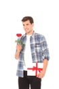 Romantic young man with red rose and gift box isolated on white. Mock up and copy space. Valentines day Royalty Free Stock Photo