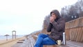 Romantic young man relaxing on the beach with , drinking hot tea or coffee from thermos. Calm and cozy evening. Royalty Free Stock Photo